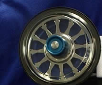 
                            
                                A circular device with several spokes emanating from the center to the edge. A knob is in the center of the device. 
                            
                            